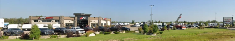 Line of used cars and trucks on a car dealer's lot